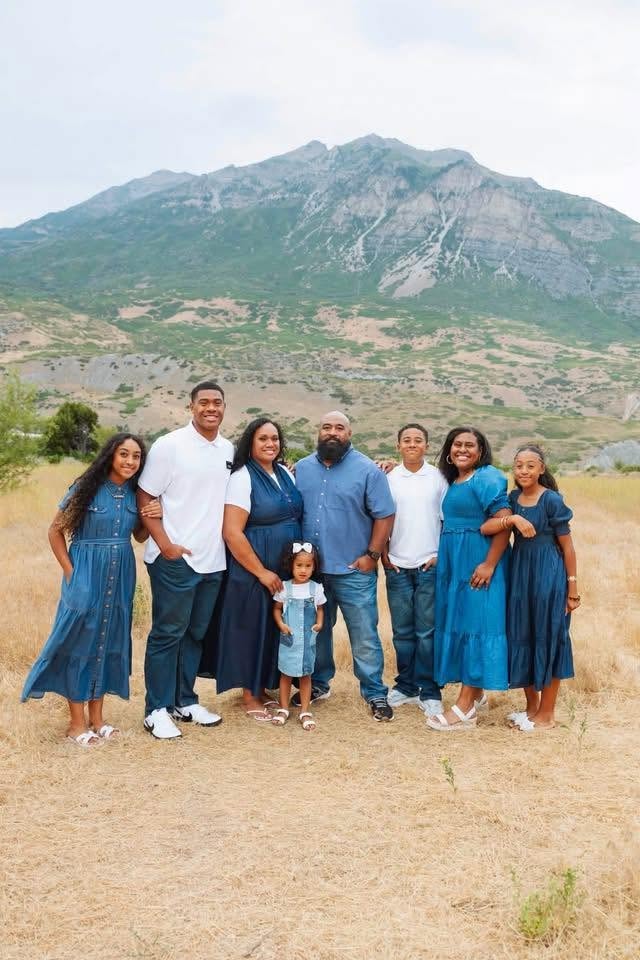 The Bird's Eye View Tree Services family — parents and six children in front of Utah mountains
